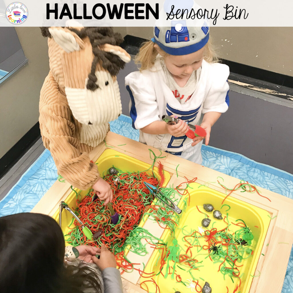 Halloween Sensory Bin Idea: Monster Noodles for Preschool and Pre-K (dyed spaghetti with plastic spiders, skeletons, eyeballs, and skulls)